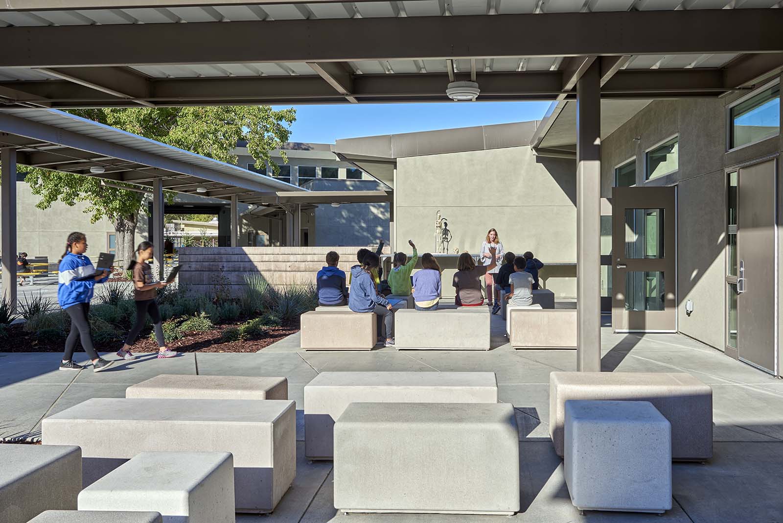 Outdoor sitting area with kids at Tice Creek School