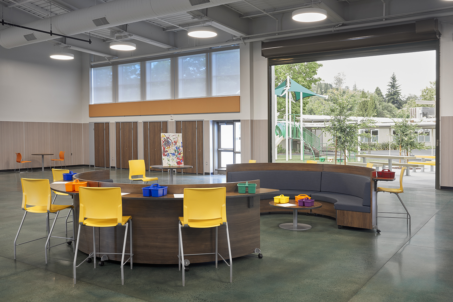 Indoor space with tables and chairs at Tice Creek School