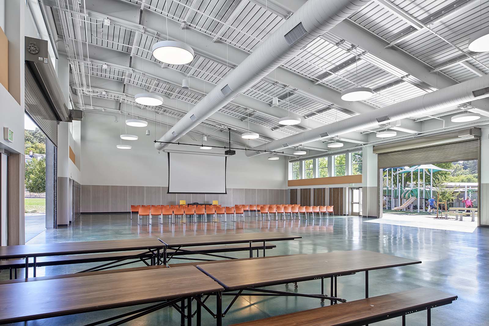 Large indoor space with picnic tables at Tice Creek School